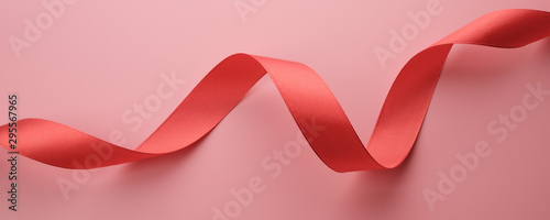 Red ribbon on pink background, banner concept
