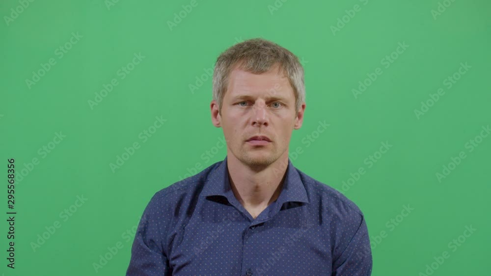 Adult Man Remove Adhesive Tape Covering The Mouth Like It Won'T Be Quiet Anymore. Studio Isolated Shot Against Green Screen Background Adult Man Remove Adhesive Tape Covering The Mouth Like It Won'T Be Quiet Anymore. Studio Isolated Shot Against Green Screen Background