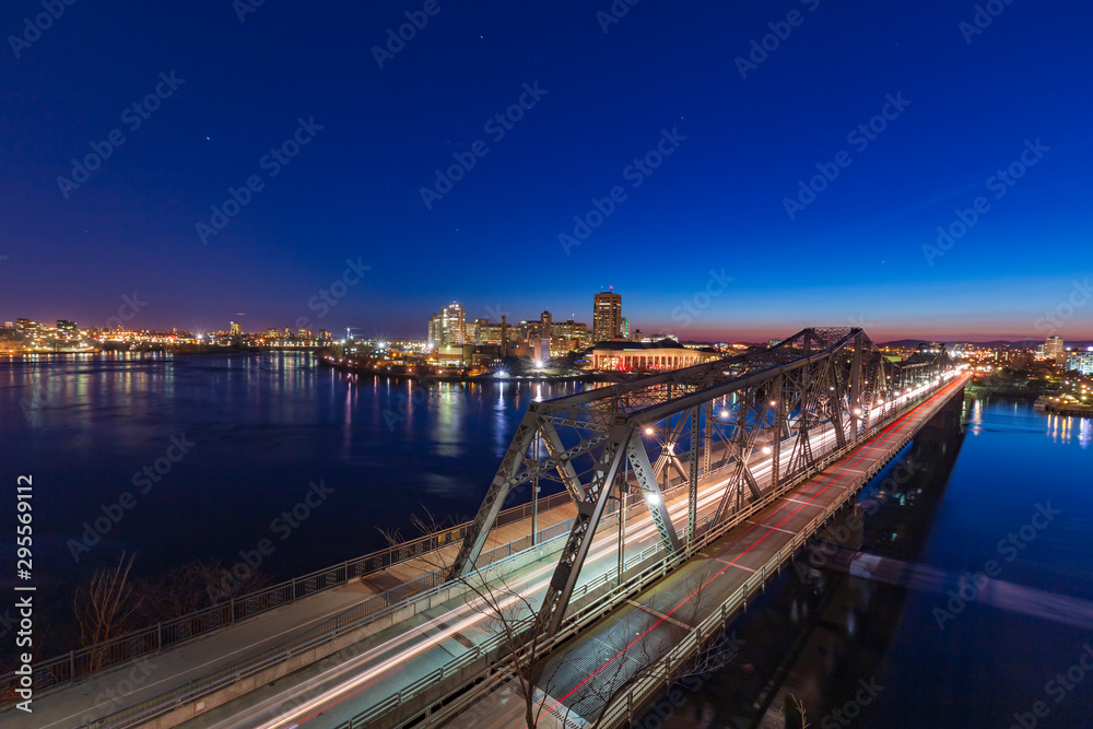 A bridge over a river in a city at night A bridge over a river in a city at night