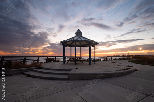 Gazebo in a Park with a Picnic Table with a Colorful Sunset Sky Background