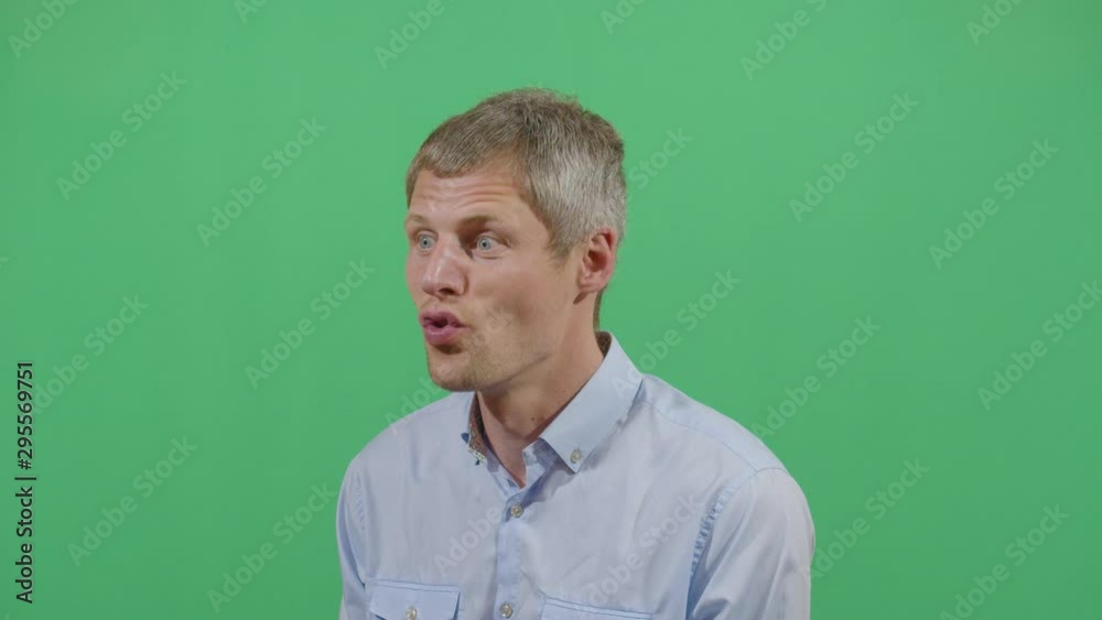 Adult Man Saying Woo At The Viewer From A Calm State To An Unpredictable Posture. Studio Isolated Shot Against Green Screen Background Adult Man Saying Woo At The Viewer From A Calm State To An Unpredictable Posture. Studio Isolated Shot Against Green Screen Background