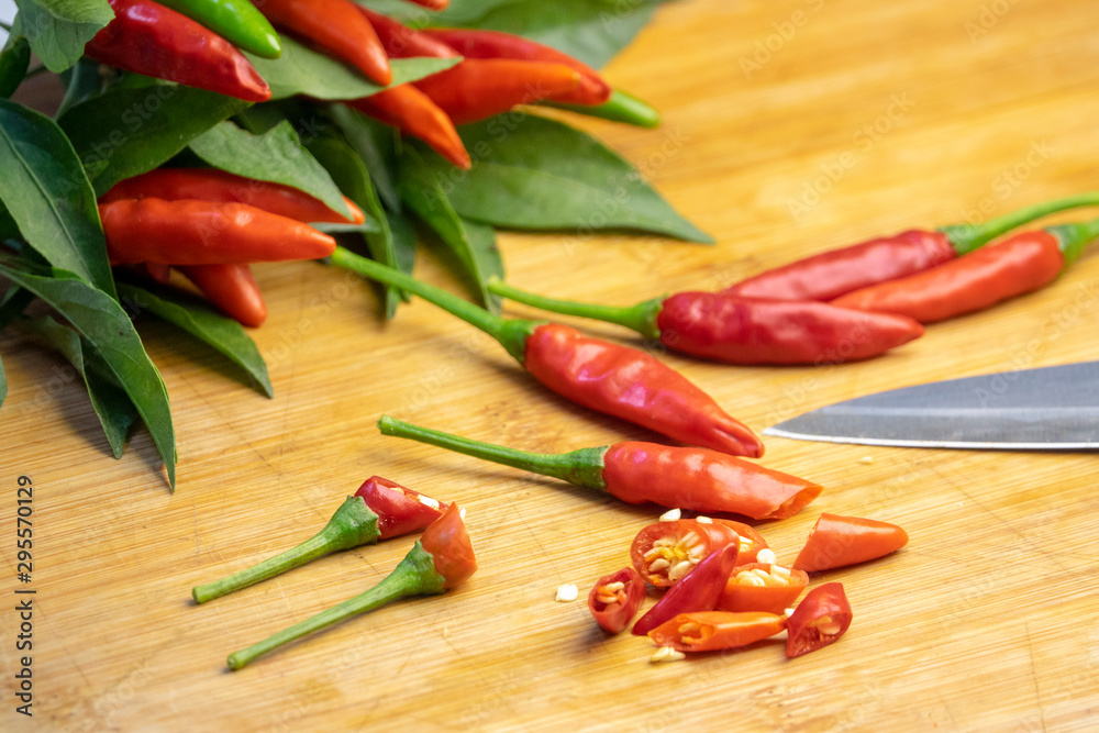 red chili peppers on wooden board red chili peppers on wooden board