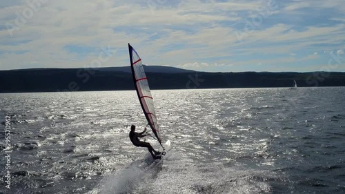Low, fast and dramatic windsurfing aerial shot from a drone photo