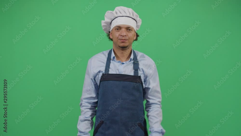 Funny Adult Man Cook Using A Chinese Knife To Scare Cheap Customers. Studio Isolated Shot Against Green Screen Background