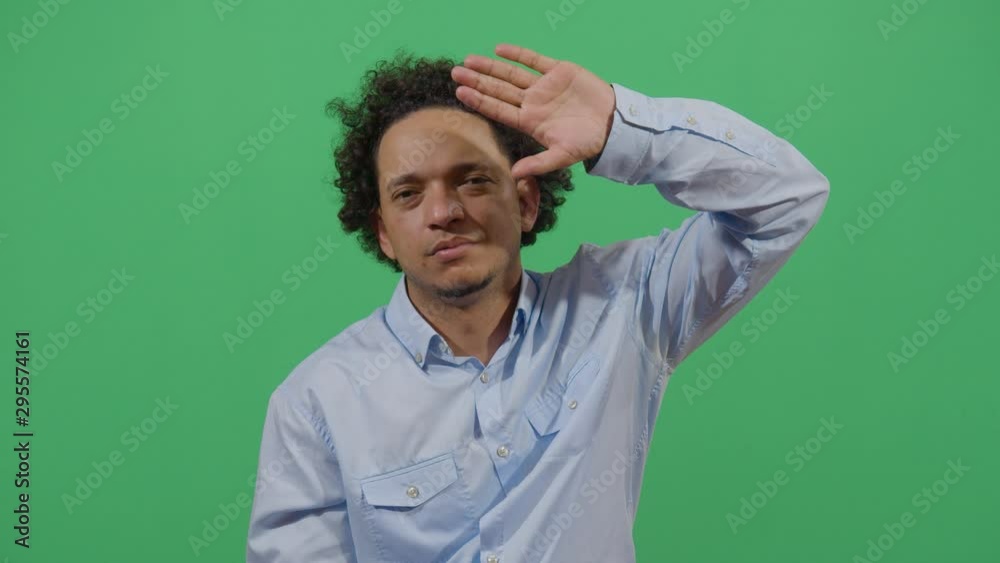 Adult Man Using The Hand As A Shade. Studio Isolated Shot Against Green Screen Background Adult Man Using The Hand As A Shade. Studio Isolated Shot Against Green Screen Background
