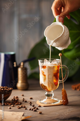 Iced coffee in glass with cream