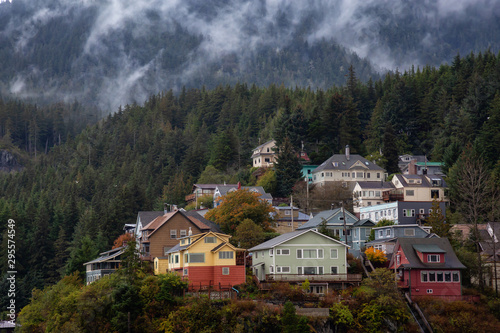 Fototapeta Naklejka Na Ścianę i Meble -  Beautiful Aerial View of residential homes on top of  hill in a small touristic town in the Ocean Coast during a stormy and rainy morning. Taken in Ketchikan, Alaska, United States