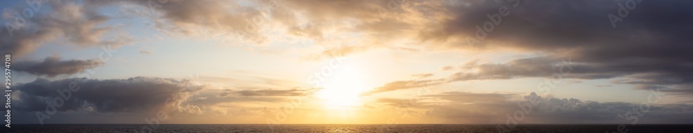 Obraz premium Dramatic Panoramic View of a cloudscape during a dark, rainy and colorful sunset. Taken on the Ocean Coast of Alaska, USA.
