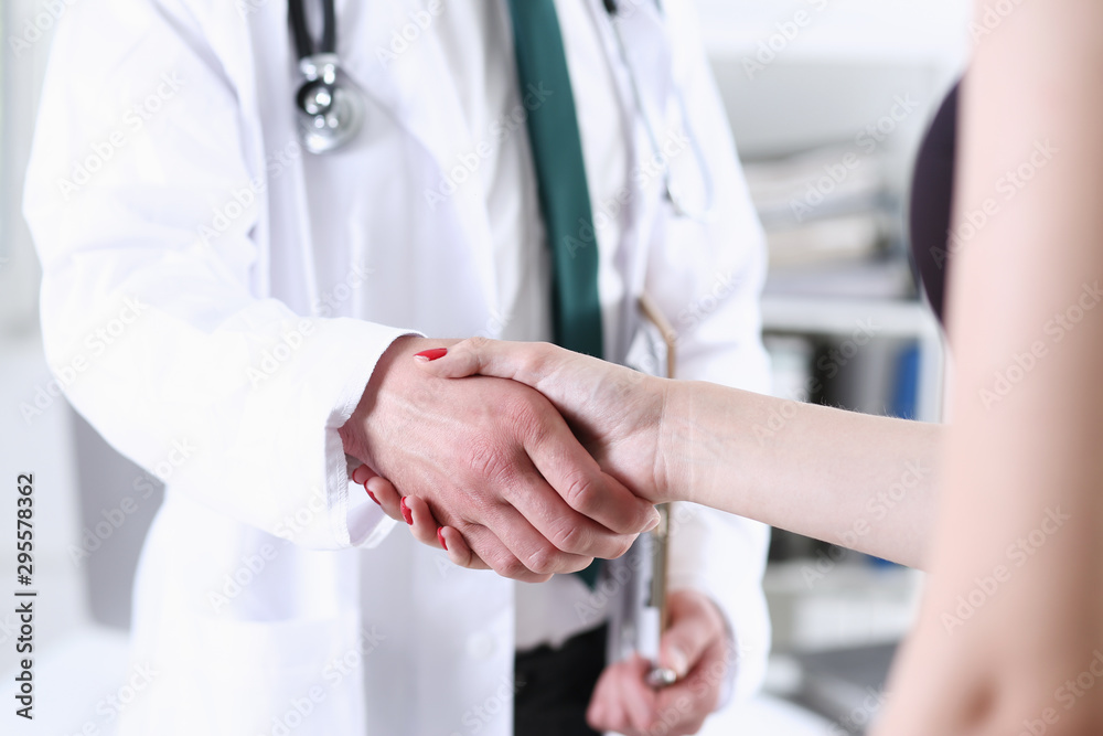 Doctor shake hand as hello with patient in Doctor shake hand as hello with patient in