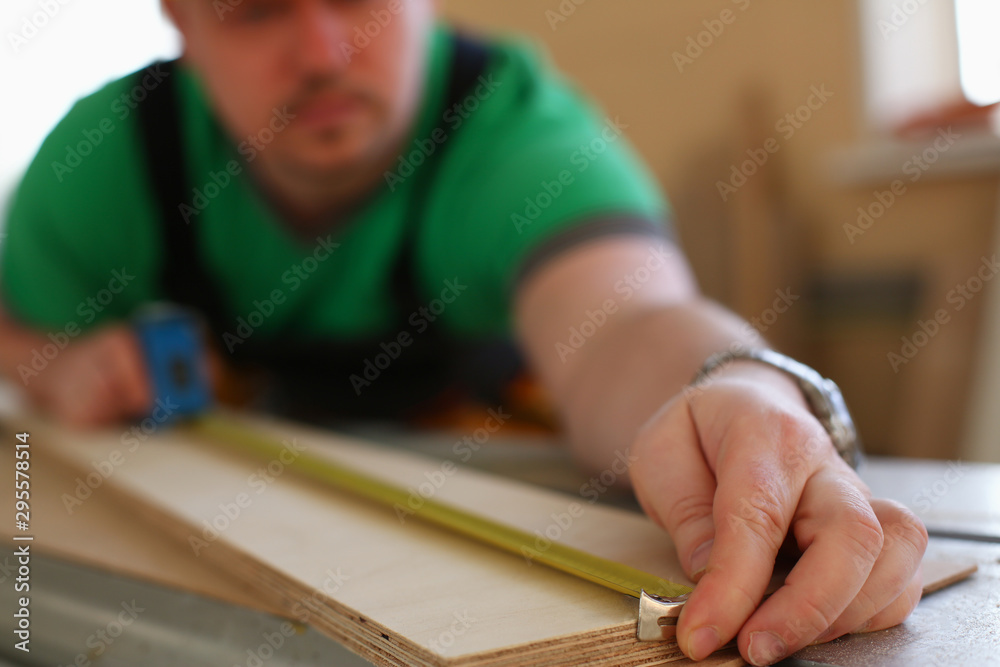 Handsome worker measuring. Manual Handsome worker measuring. Manual