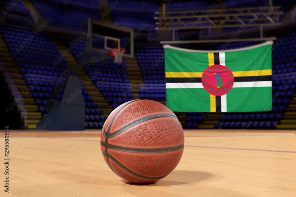 Naklejka premium Dominica flag and basketball on Court Floor