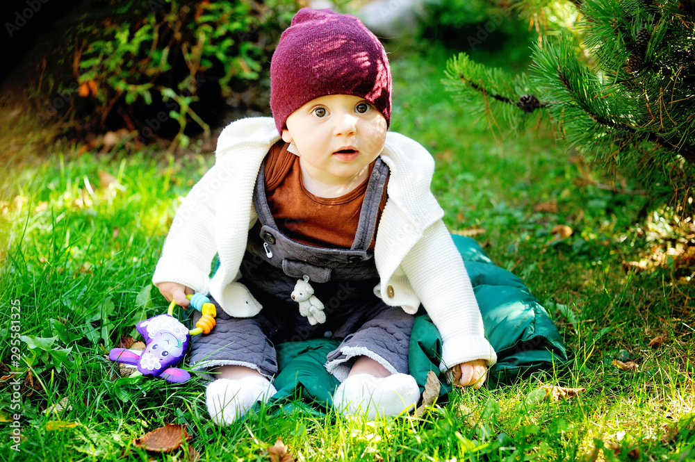 Cute newborn baby in warm wool knitted hat and sweater