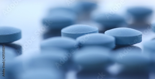 Tablets scattered blue color on the table of pharmaceutical laboratory pill for the prescription and treatment various diseases chemistry photo