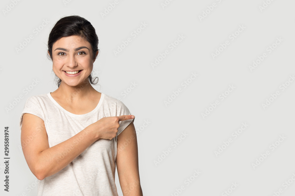 Smiling indian girl point at blank copy space aside Smiling indian girl point at blank copy space aside
