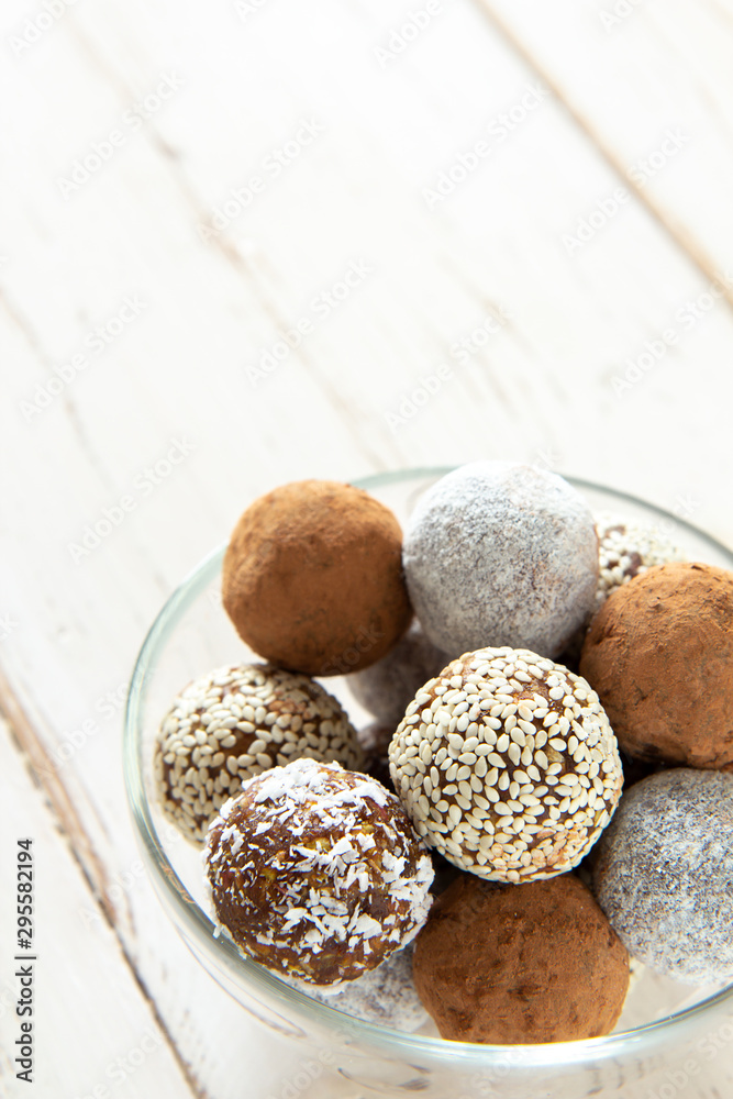 Energy balls in a glass bowl on a white background Energy balls in a glass bowl on a white background