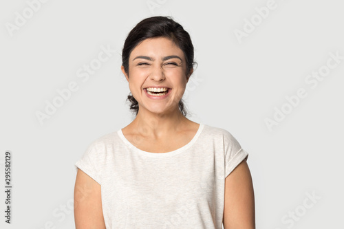 Overjoyed indian girl laugh posing on grey background