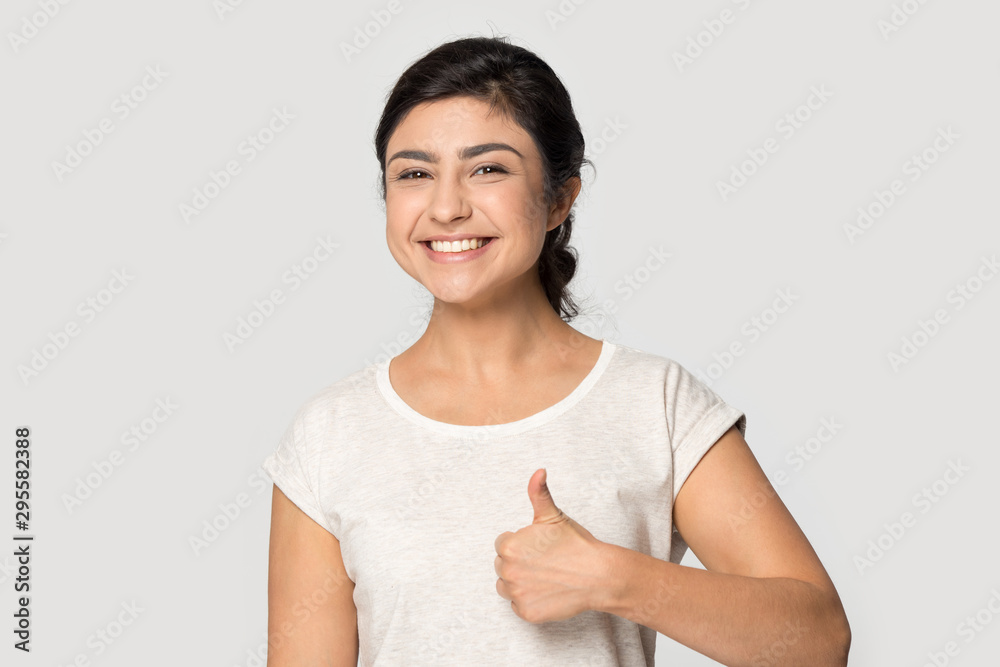 Smiling Indian girl show thumbs up recommending service Smiling Indian girl show thumbs up recommending service