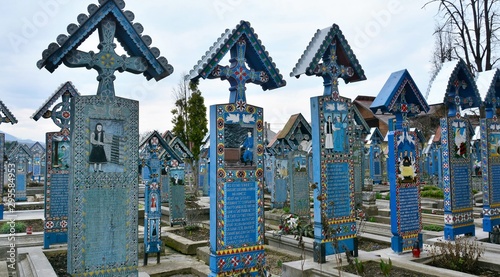 Merry Cemetery in Sapanta, Maramures County - Romania. Mar.12.2016. The cemetery is famous for the crosses of brightly colored tombs and naive paintings representing scenes from the lives of strangers photo