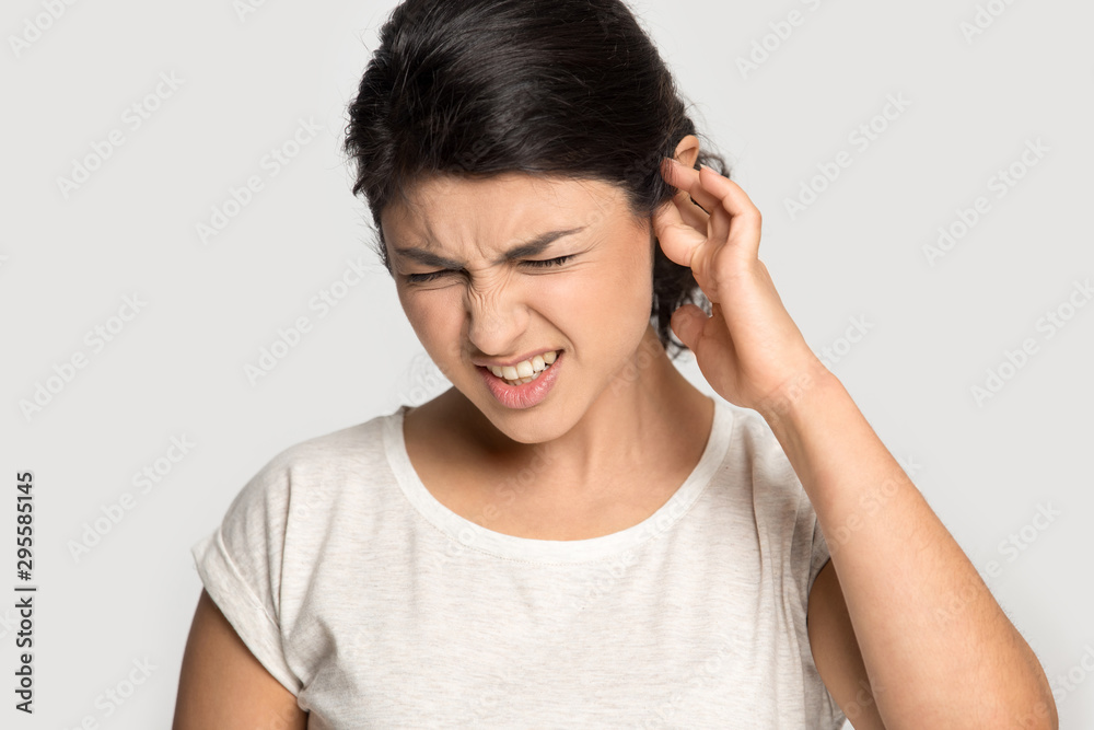 Unhappy indian girl annoyed by loud noise Unhappy indian girl annoyed by loud noise