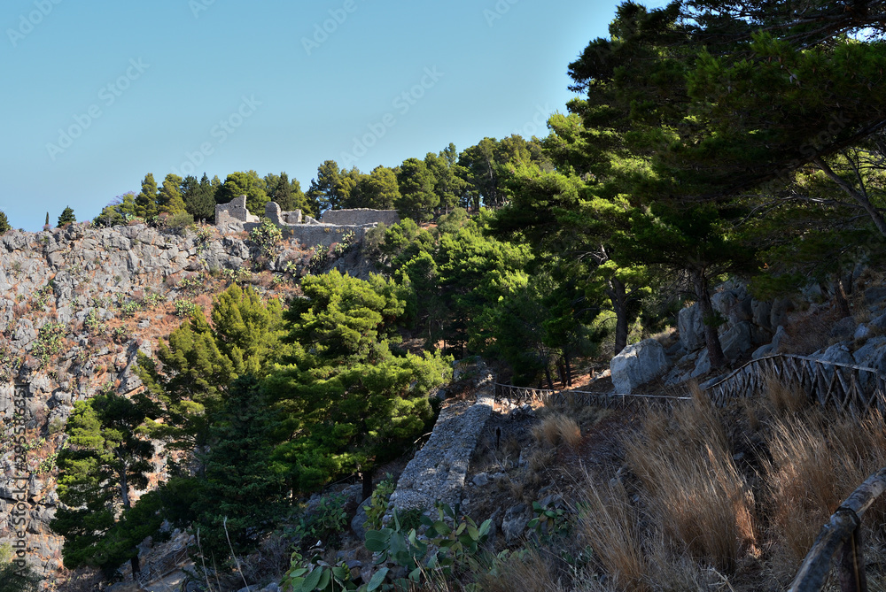 The slope of La Rocca mountain near the Cefalu city on a sunny summer's day. Sicily, Italy