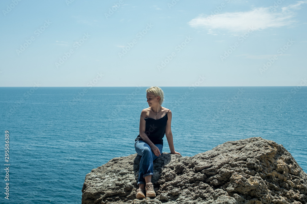 nice girl on a rock near the sea