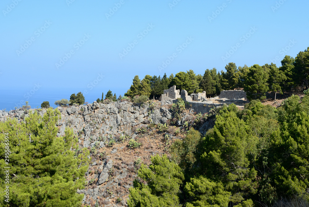 The slope of La Rocca mountain near the Cefalu city on a sunny summer's day. Sicily, Italy