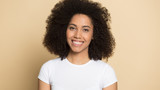 Headshot of smiling african American girl posing in studio