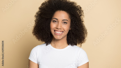 Headshot of smiling african American girl posing in studio © fizkes