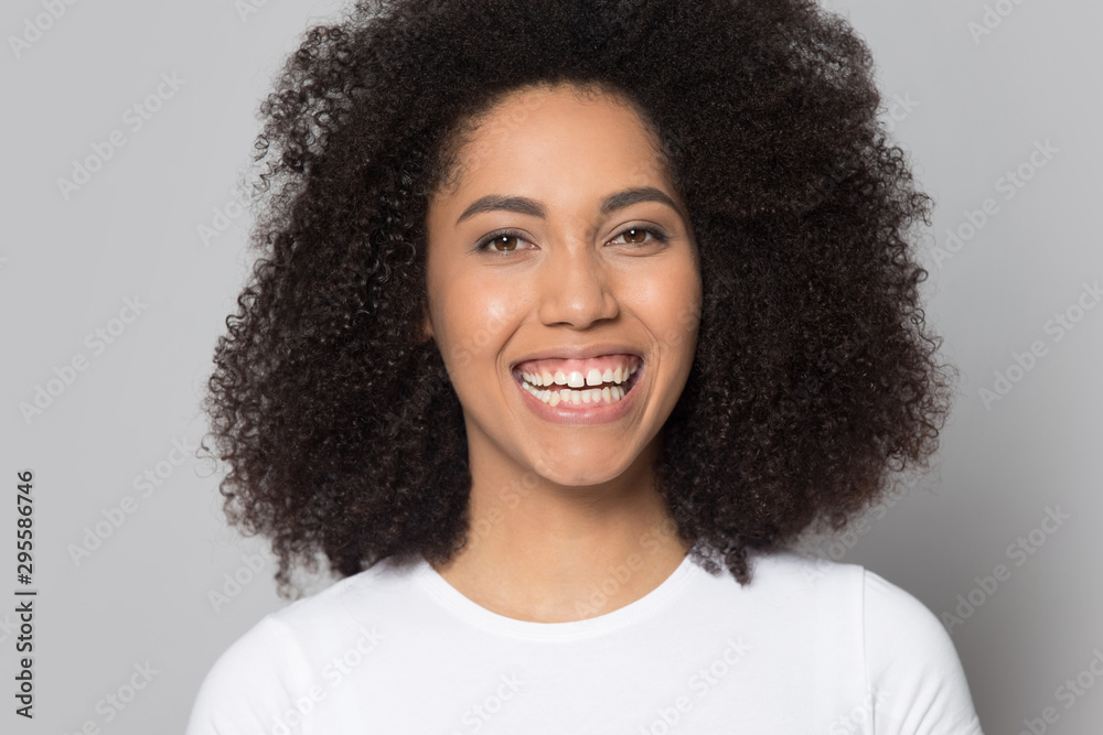Portrait of smiling biracial girl laugh isolated on studio background Portrait of smiling biracial girl laugh isolated on studio background