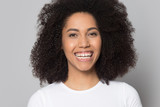 Portrait of smiling biracial girl laugh isolated on studio background