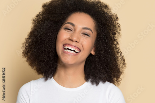 Headshot of smiling african American girl posing in studio © fizkes
