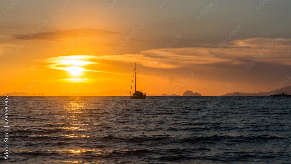 Yacht at anchor at sunset