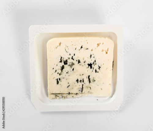 Blue cheese in disposable plastic box. Isolated with clipping path. Directly Above.