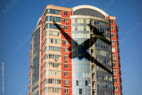 Fotografie Airplane shadow on skyscraper building