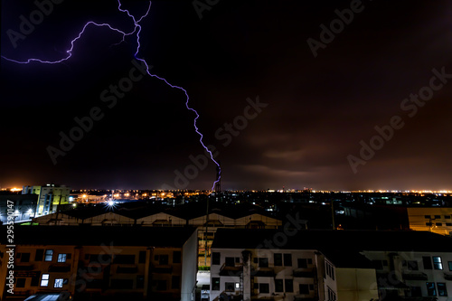 Obraz na płótnie Lightning bolt strikes tower in industrial area at night. w salonie