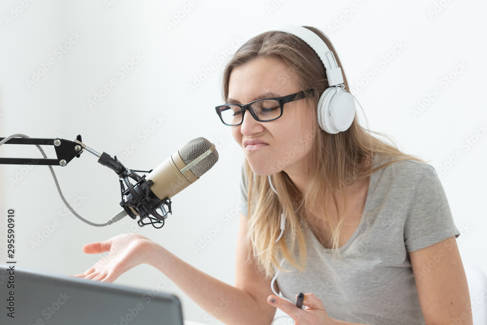 Naklejka premium Music, dj, blogging and broadcasting concept - Female radio host with a funny expression, close-up