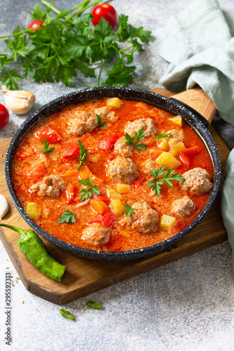 Spanish and Mexican food - Albondigas. Hot stew tomato soup with meatballs and vegetables. Free space for your text.
