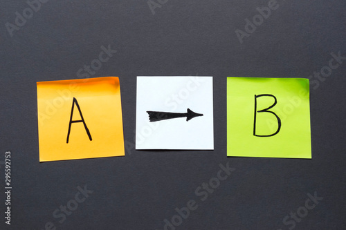 Letters A and B and different arrows on the dark background, destination concept.