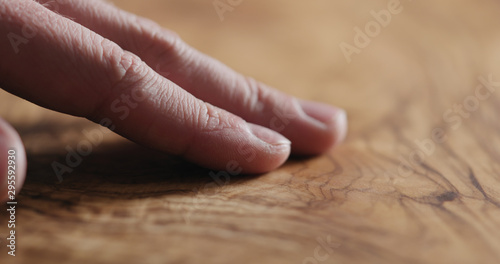 man hand touch oil finished olive wood surface