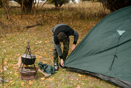 Portrait of a man setting up a tent on a camping trip