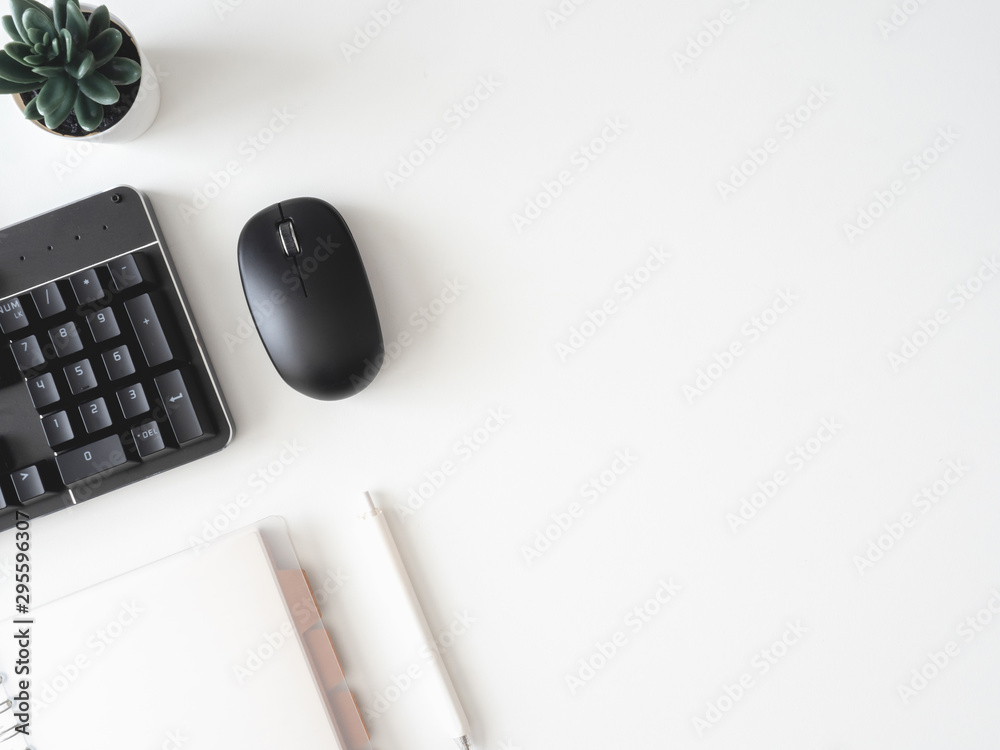 top view of office desk table with calculator, notebook, plastic plant, smartphone and keyboard on white background, graphic designer, Creative Designer concept. top view of office desk table with calculator, notebook, plastic plant, smartphone and keyboard on white background, graphic designer, Creative Designer concept.