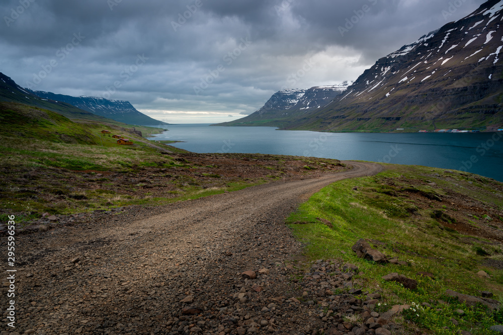 An Icelandic gravel road leads to the ocean shore
