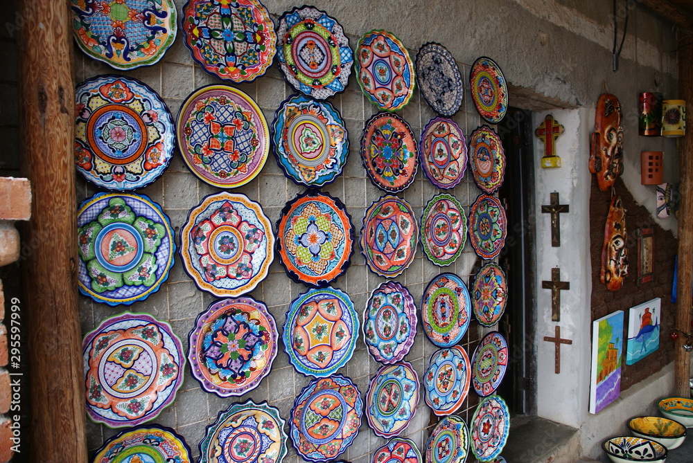 multi-colored decorative plates on the wall of the house