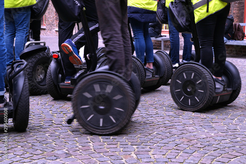 driving school for hoverboard in yellow safety vests, active people balancing on modern electric scooter. alternative transport concept, electric city transportation, mobile eco vehicle concept