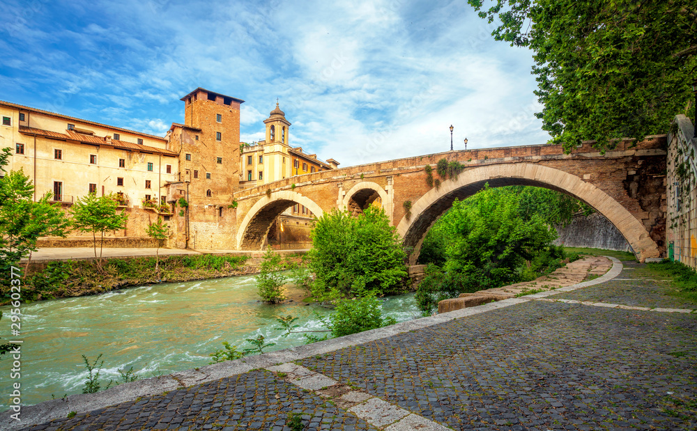 Tiber Island and Fabricius Bridge on the river Tiber in Rome, Italy. Exterior, architecture and landmark of ancient streets in Rome.