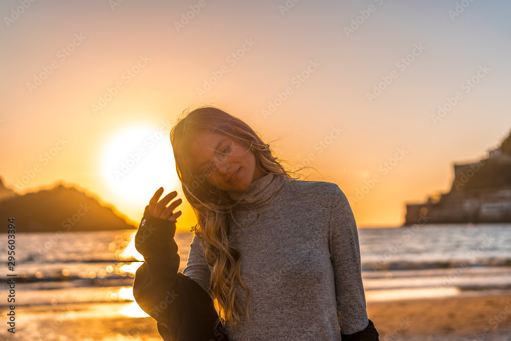 A smiling blonde in a Lifestyle session on a beach A smiling blonde in a Lifestyle session on a beach