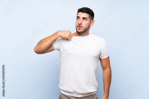 Caucasian handsome man over isolated blue background with tired and sick expression