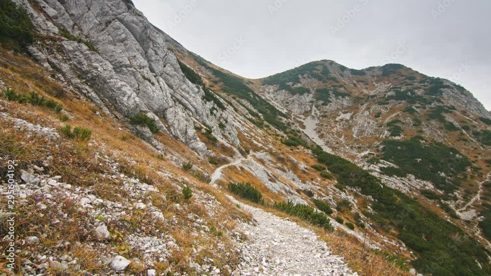 Beautiful view of rocky path hiking trail in Julian Alps. Colorful autumn mountain range. Travel Vacation Nature Beauty Concept. Beautiful view of rocky path hiking trail in Julian Alps. Colorful autumn mountain range. Travel Vacation Nature Beauty Concept.