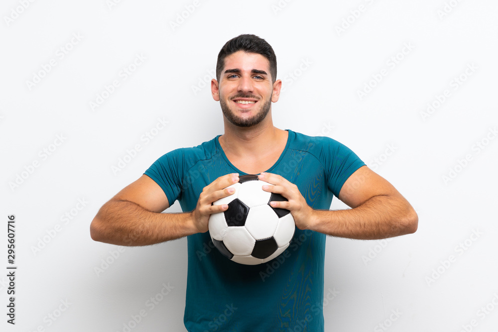 Handsome young football player man over isolated white wall