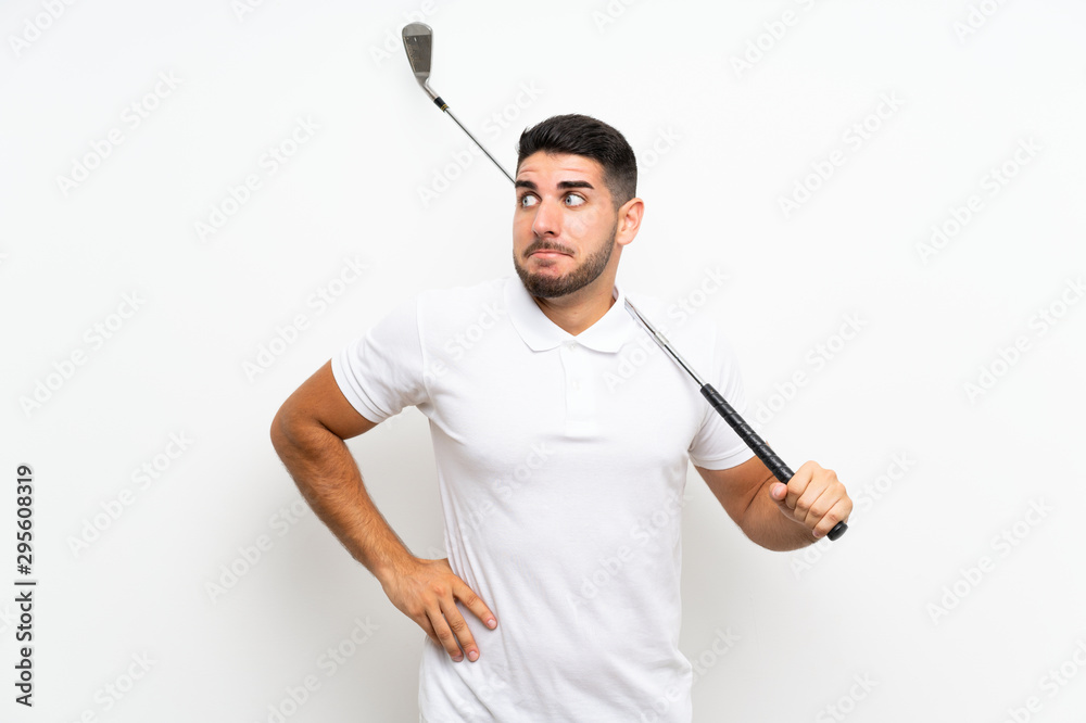Handsome young golfer player man over isolated white background making doubts gesture while lifting the shoulders Handsome young golfer player man over isolated white background making doubts gesture while lifting the shoulders
